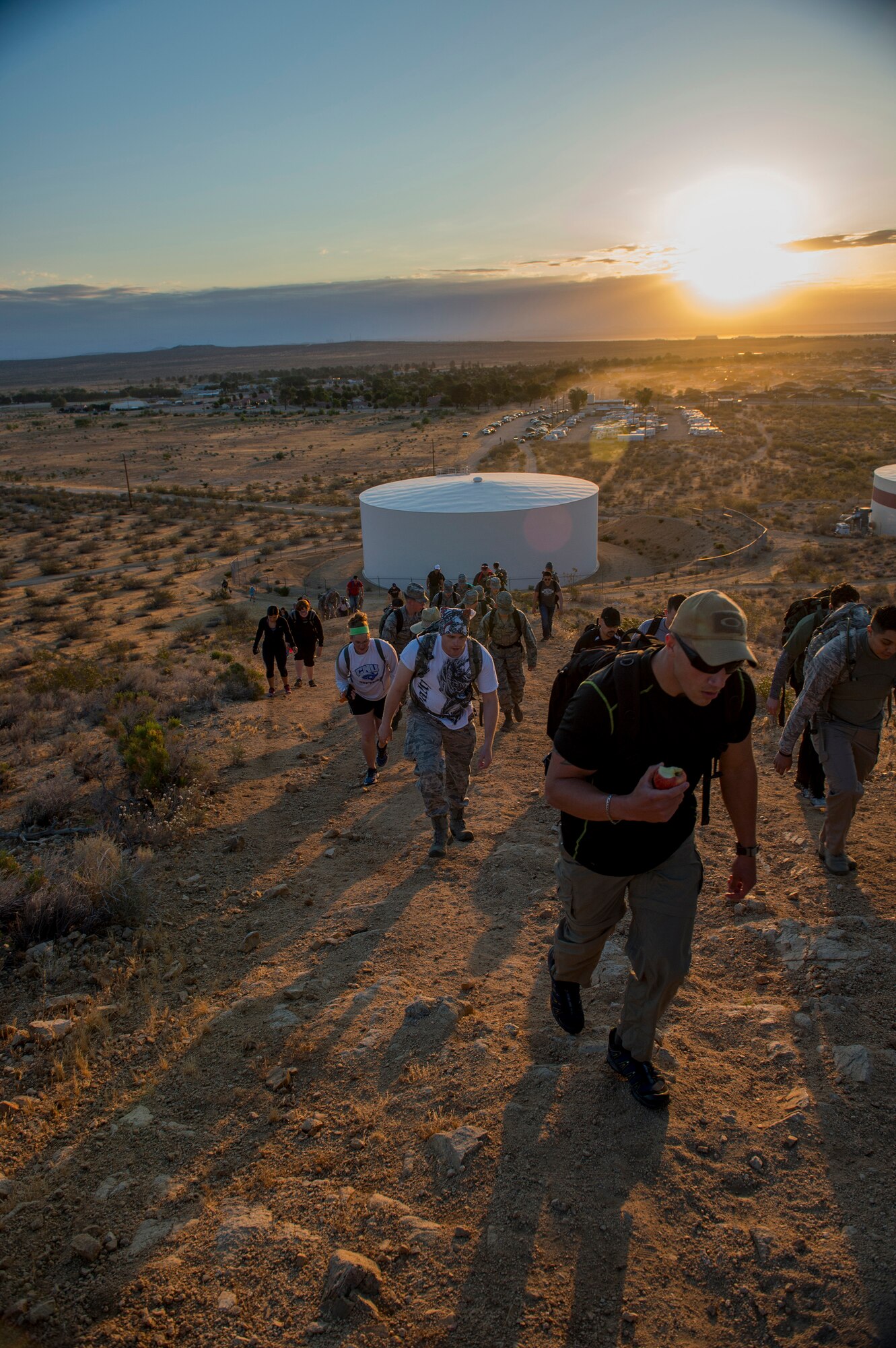 Marchers begin their trek up the first hill during a 14-kilometer ruck march here Tuesday. The march was held as part of Police Week observances. Each kilometer represents a fallen Air Force Security Forces member. (U.S. Air Force Photo by Joseph Pol Gocon.)