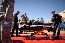 Emergency responders from agencies surrounding Hill Air Force Base move a simulated victim during a mass casualty exercise May 18 at the base. The exercise revolved around a terrorist incident resulting in a mass casualty scenario. Approximately 200 students from the Clearfield (Utah) Job Corps and nearly 30 emergency response agencies, including local hospitals, fire departments, law enforcement and emergency operation centers participated. (U.S. Air Force photo by R. Nial Bradshaw)
