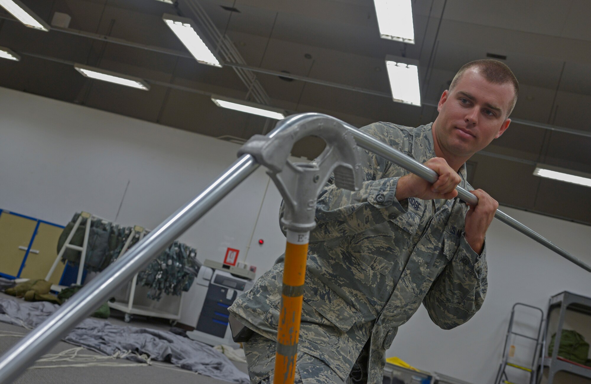 Staff Sgt. Corey Trowbridge, 932nd Civil Engineer Squadron electrical systems technician, from Scott Air Force Base, Illinois, bends raceway pipe at Yokota Air Base, Japan, May 17, 2016. The electrical flight used approximately 70 feet of pipes to set up a motorized air compressor. (U.S. Air Force photo by Senior Airman David Owsianka/Released)