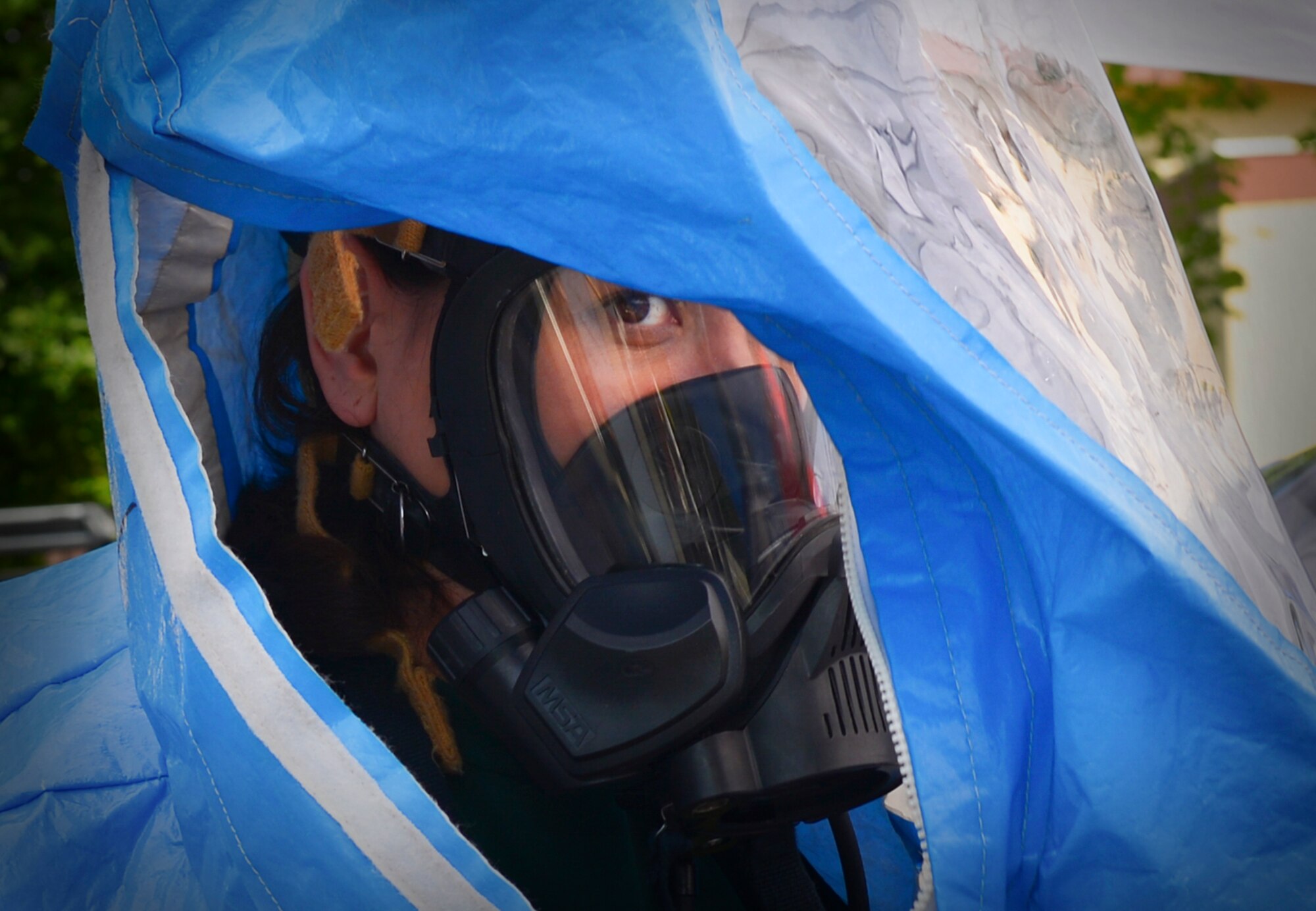 Tech. Sgt. Lisa Brow, 374th Civil Engineer Squadron NCO in charge of training, dons chemical protection gear at Yokota Air Base, Japan, May 13, 2016. Personnel were tested on their ability to assess a simulated chemical threat under various pressures such as a managing oxygen supply, time constraints and the physical challenges of wearing chemical protection gear. (U.S. Air Force photo by Airman 1st Class Elizabeth Baker/Released)