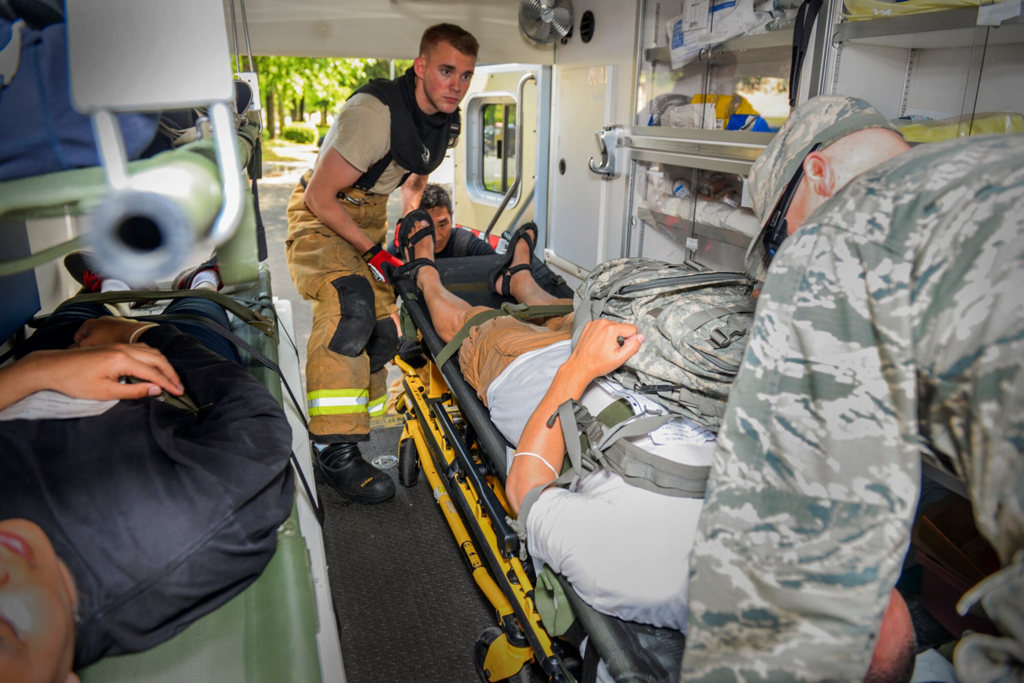 Airman 1st Class Thomas Smith, 374th Civil Engineer Squadron fire fighter, and Staff Sgt. Benjamin Smith, 374th Aerospace Medical Squadron NCO in charge of flight medicine clinic, load a simulated trauma and hazardous chemical victim into an ambulance at Yokota Air Base, Japan, May 13, 2016. Personnel with the 374 CES and 374 AMDS practiced emergency procedures during an exercise which tested Yokota’s ability to respond to an active shooter, hazardous materials and chemical attacks. (U.S. Air Force photo by Airman 1st Class Elizabeth Baker/Released) 