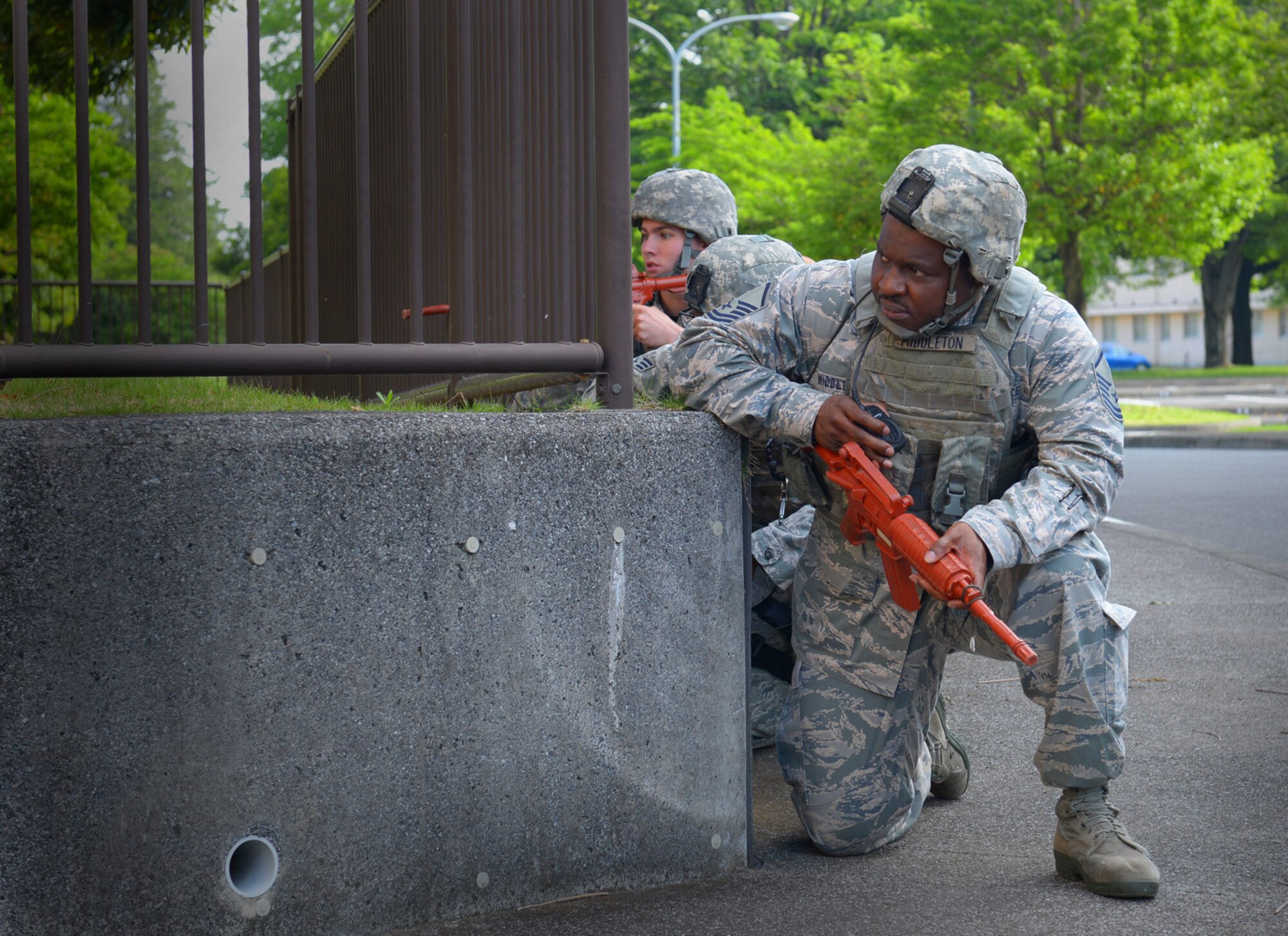Master Sgt. Billy Middleton, 374th Security Forces Squadron flight chief, leads a response team to neutralize a simulated active shooter at Yokota Air Base, Japan, May 18, 2016. Members of the 374 SFS participated in a roleplaying scenario in which they entered a hostile premises and neutralized a simulated active shooter. (U.S. Air Force photo by Airman 1st Class Elizabeth Baker/Released)