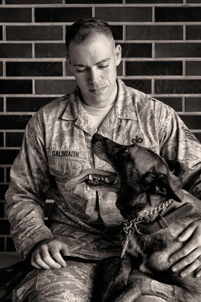 Staff Sgt. Nicholas Galbraith, 374th Security Forces Squadron military working dog handler, relaxes with his canine, Topa, in between events at Yokota’s Top Dog competition at Yokota Air Base, Japan, May 16, 2016. Seven canine teams participated in the competition as part of Police Week, a week of events and ceremonies honoring Security forces Airmen, Air Force Office of Special Investigations agents and all other law enforcement officers who have served. (U.S. Air Force photo by Senior Airman Delano Scott/Released)
