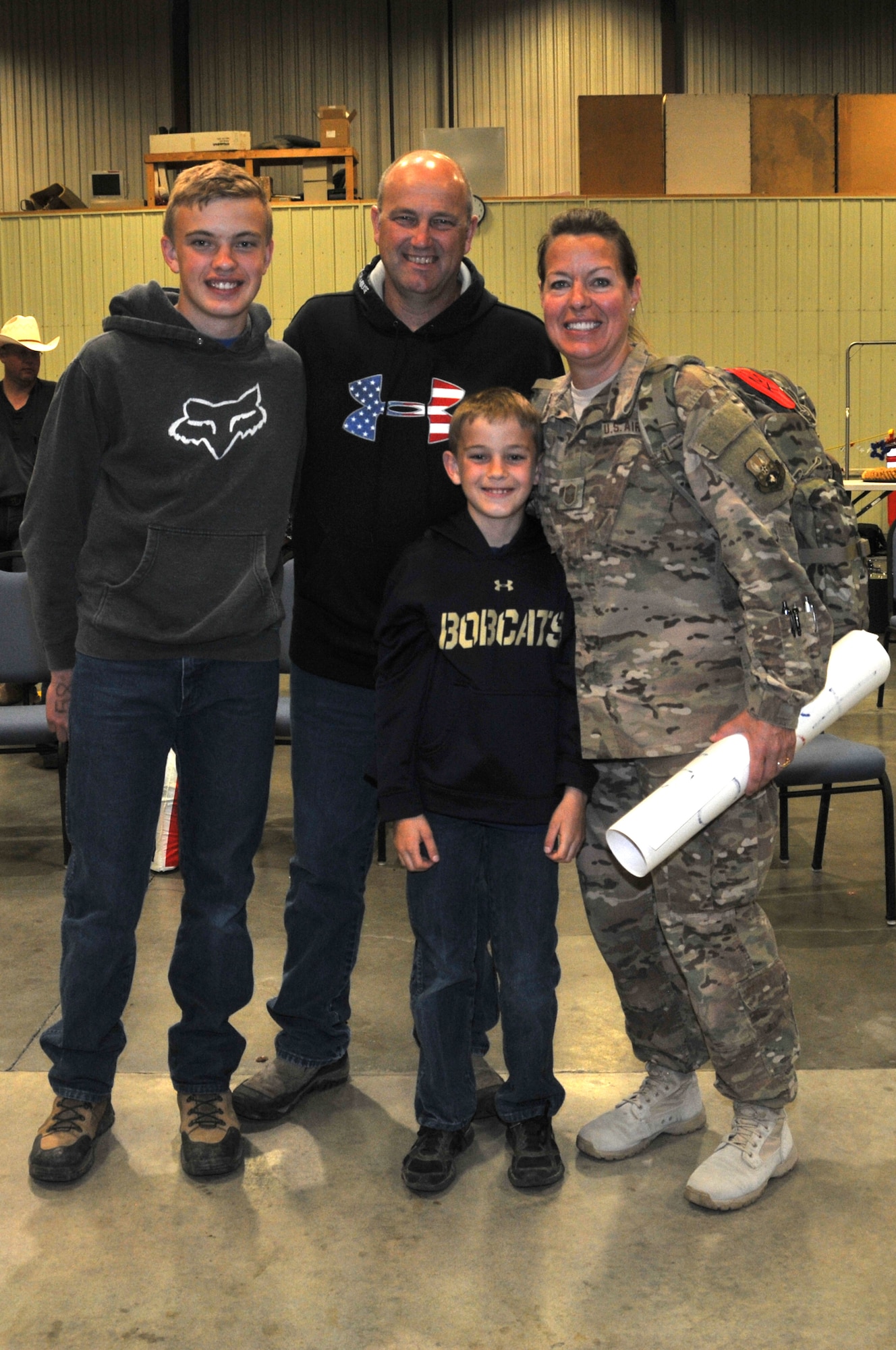 120th Airlift Wing Senior Master Sgt. Heather Kelley is welcomed home from her deployment to Southwest Asia by family members (left to right) son, Jacob, husband Chief Master Sgt. Randy Kelley, and son Luke. The returning Airmen were met by a reception of family members and friends in a hangar at Holman Aviation at the Great Falls International Airport May 7, 2016. (U.S. Air National Guard photo by Senior Master Sgt. Eric Peterson)
