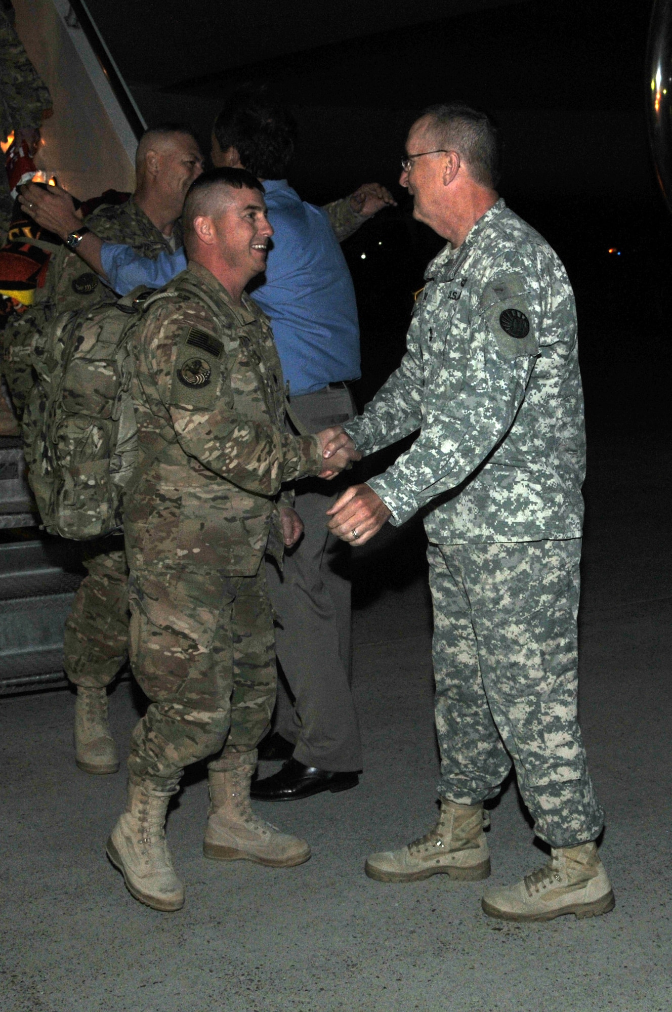 Montana Adjutant General Maj. Gen. Matthew Quinn greets 219th RED HORSE Squadron Commander Lt. Col. Rusty Vaira as he steps off of the airliner that carried him and members of the 219th RHS home from their deployment to Southwest Asia, May 7, 2016. A reception of family members and friends gathered in a hangar at Holman Aviation at the Great Falls International Airport to greet the returning Airmen. (U.S. Air National Guard photo/Senior Master Sgt. Eric Peterson)