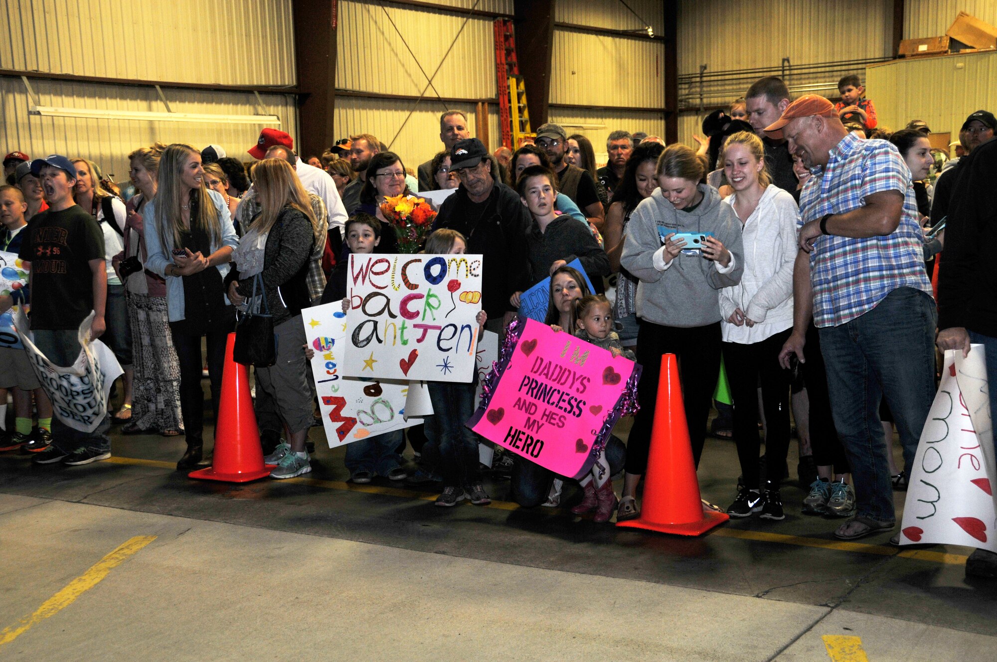 Family members and friends wait in a hangar at Holman Aviation at the Great Falls International Airport for the arrival of the airliner carrying members of the 219th RED HORSE Squadron home from a Southwest Asia deployment May 7, 2016. (U.S. Air National Guard photo/Senior Master Sgt. Eric Peterson)