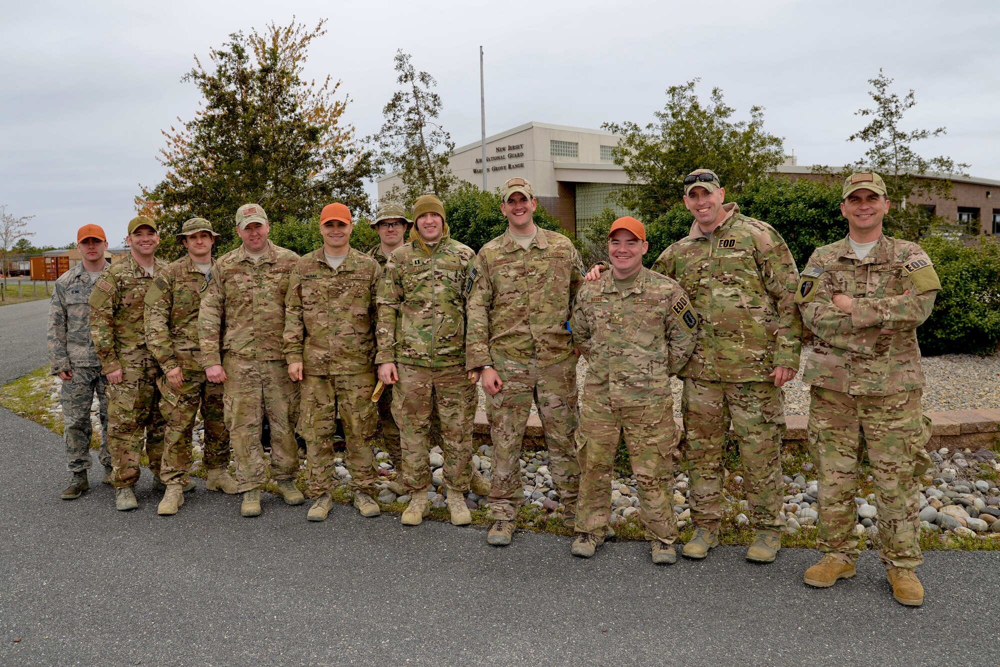 A picture of U.S. Air Force Explosives Ordnance Disposal (EOD) technicians and civil engineers with the New Jersey Air National Guard's 177th Fighter Wing and the 87th Civil Engineering Squadron, Joint Base McGuire-Dix-Lakehurst, N.J. posing for a group photo.