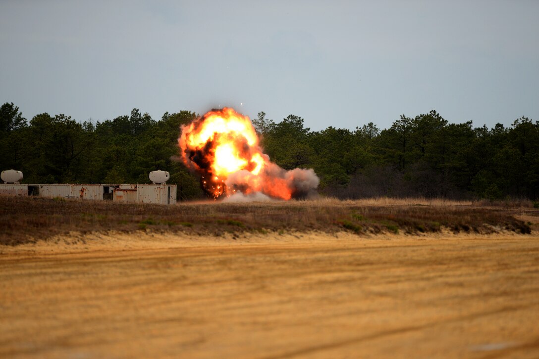 C-4 explosives are triple stacked and detonated on used BDU-50 500 lb. concrete-filled practice bombs to render them safe for recycling at Warren Grove Range in Ocean County, N.J. on April 29, 2016. U.S. Air Force Explosive Ordnance Disposal techs, civil engineers and range crew from the 177th Fighter Wing of the New Jersey Air National Guard and the 87th Civil Engineering Squadron at Joint Base McGuire-Dix-Lakehurst worked together during the annual EOD Week At The Range to perform range clean-up and target painting, as well as target set-up in the simulated village. (U.S. Air National Guard photo by Master Sgt. Andrew J. Moseley/Released)