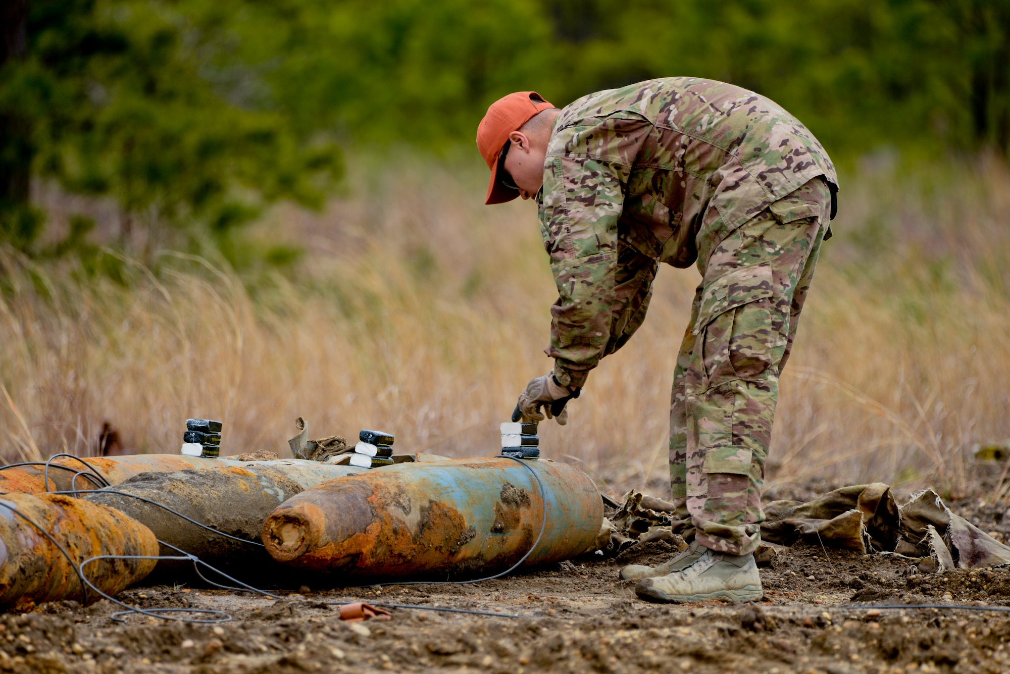 A picture of U.S. Air Force Airman 1st Class Michael Glisan, Explosives Ordnance Disposal Technician with the 87th Civil Engineering Squadron, Joint Base McGuire-Dix-Lakehurst, N.J., triple stacking C-4 explosives on used BDU-50 500 lb. concrete-filled practice bombs.