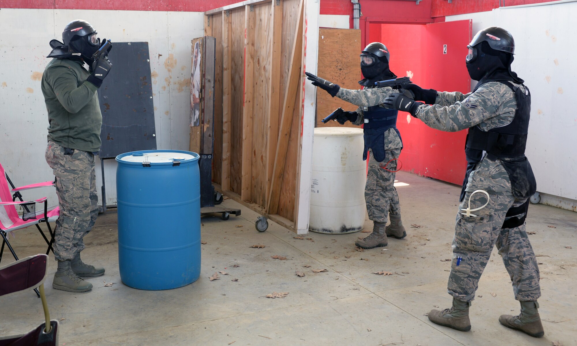 U.S. Air Force Airmen from the 157th Security Forces Squadron, attempt to detain Tech Sgt. Paul D. Lawrence II, 157 SFS unit training manager, right, during a use of force training scenario at Sig Sauer Academy, Epping, N.H. May 14, 2016. The personal protective equipment they are wearing provides them protection from the non-lethal training ammunition tipped with colored dye which they are using.  (U.S. Air National Guard photo by Airman 1st Class Ashlyn J. Correia)