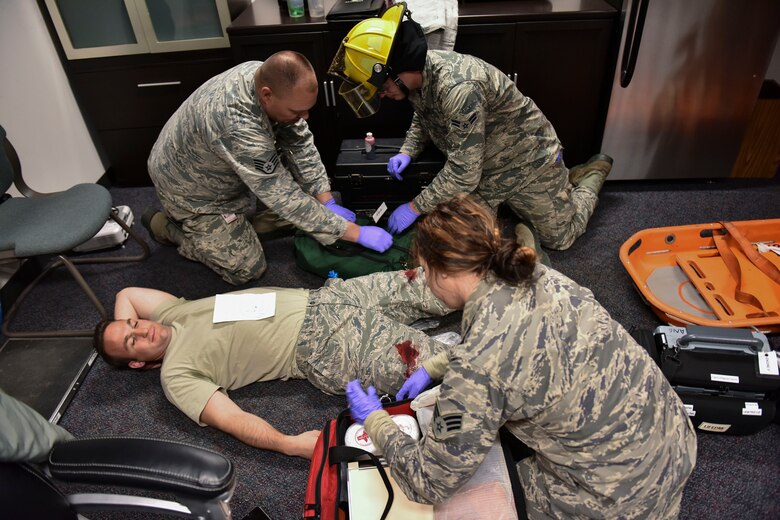 U.S. Air Force firefighters with the 180th Fighter Wing in Swanton, Ohio treat a victim with simulated gunshot wounds after Security Forces cleared the building of all suspected shooters during an active shooter exercise on base on May 15, 2016. The 180th performed a base-wide active shooter response exercise and inspection to prepare Airmen to survive an incident on base or in their civilian lives. (Ohio Air National Guard photo by Tech. Sgt. Nic Kuetemeyer/released)