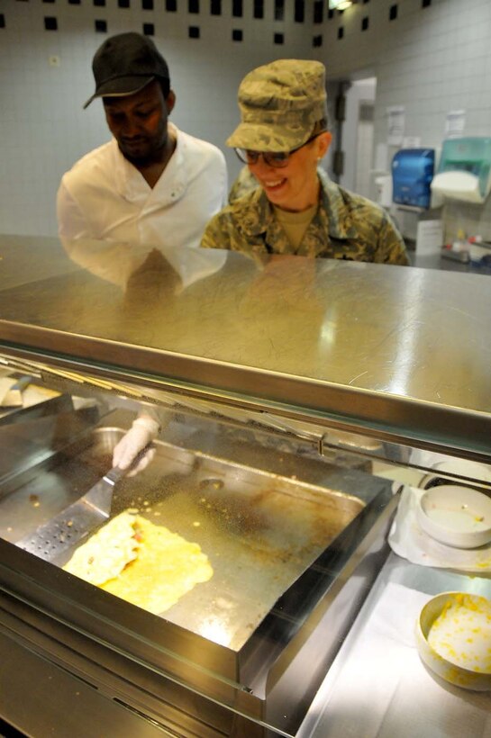 Ramstein, Germany - Master Sgt. Darci Furr from the 104th Fighter Wing serves breakfast at Rheinland Inn Dining facility, May 16, 2016.  Master Sgt. Furr is one of approximately 100 Airman from the 104th Fighter Wing, Barnes Air National Guard Base, Mass., deployed for training to Ramstein and Spangdahlem Air Bases in an effort to maintain continuous continuity between the National Guard and  Active Duty counterparts. (U.S. Air National Guard photo by Senior Airman Loni Kingston/Released)