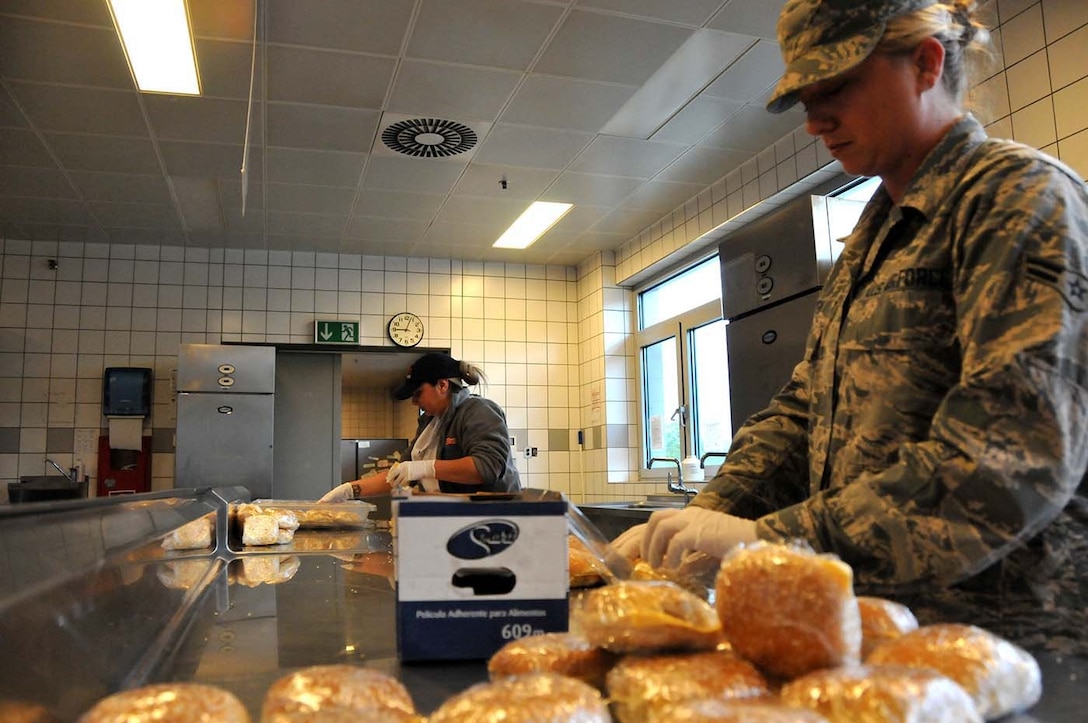 Ramstein, Germany - Airman 1st Class Clarissa Tryba prepares meals for Service Members on Ramstsein Air Base, May 16, 2016. Nearly 100 Guardsmen from the 104th Fighter Wing, Barnes Air National Guard Base, Mass., deployed for training to Ramstein and Spangdahlem Air Bases in an effort to enhance readiness and maintain continuous continuity between the National Guard and Active Duty counterparts. (U.S. Air National Guard photo by Senior Airman Loni Kingston/Released)