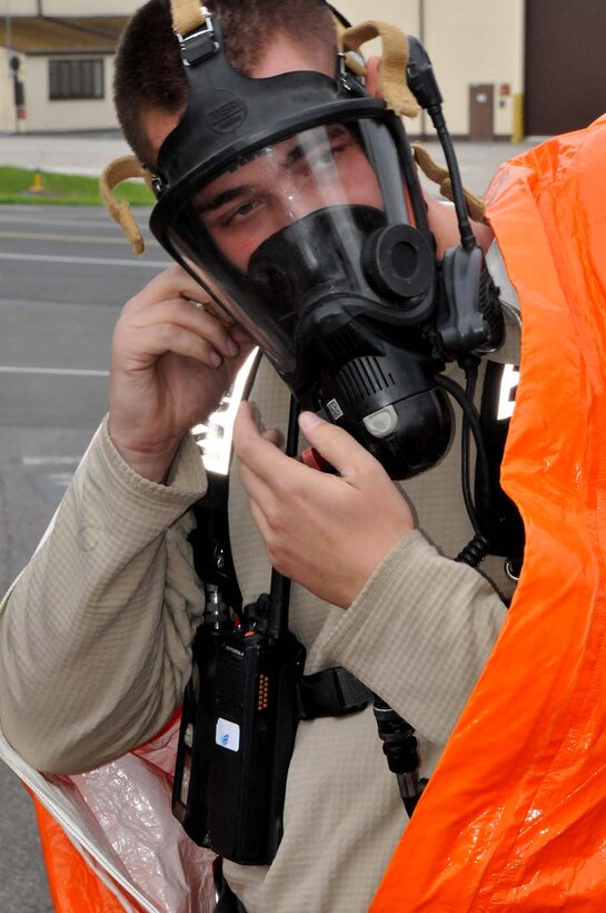 SPANGDAHLEM, Germany -   Staff Sgt. Ryan Hart dons his HAZMAT gear during a duel-component training mission with their  52nd Fighter Wing, active duty counterparts, May 18, 2016.  Hart is among nearly 100 Airmen from the 104th Fighter Wing deployed to Germany for annual training in an effort to support total force integration which combines reservists with active duty Service Members to create one seamless Air Force (U.S. Air National Guard photo by Senior Airman Loni Kingston/Released)