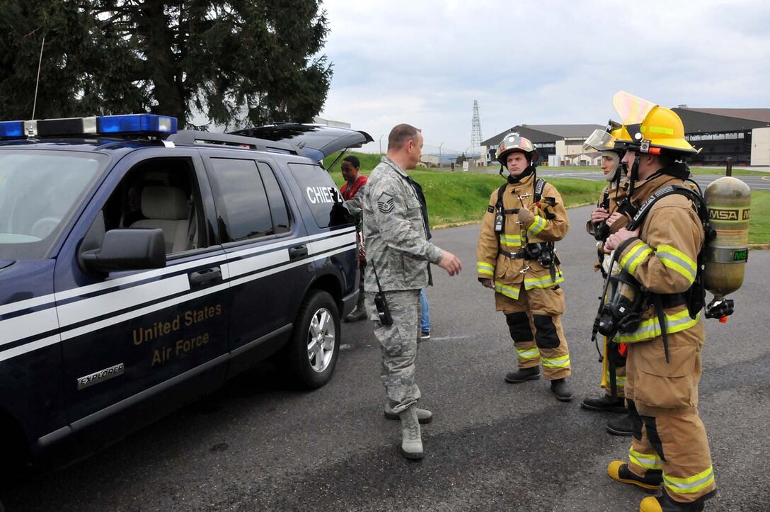 SPANGDAHLEM, Germany - Assistant Fire Chief, Master Sgt. Steven Bevier, from the 52nd Fighter Wing discusses rescue procedures with firefighters from the 104th Fighter Wing, Barnes Air National Guard Base, Mass., and their active duty counterparts from the 52nd Fighter Wing, May 18, 2016. Nearly 100 Airmen from the 104th Fighter Wing deployed to Germany for annual training in an effort to support total force integration which combines reservists with active duty Service Members to create one seamless Air Force (U.S. Air National Guard photo by Senior Airman Loni Kingston/Released)