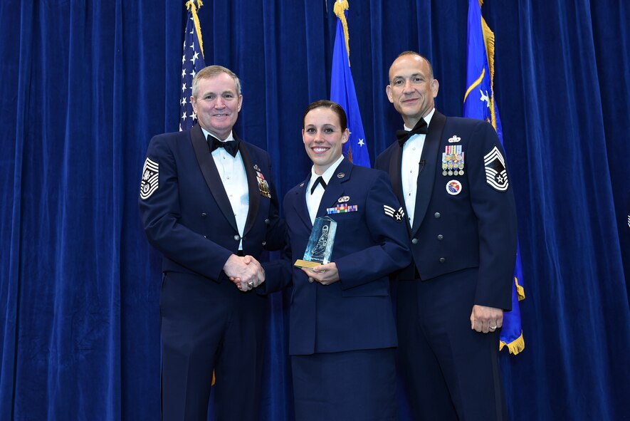 MCGHEE TYSON AIR NATIONAL GUARD BASE, Tenn. - Senior Airman Amy Smyser, center, takes the leadership award here May 18, 2016, for the Airman leadership school, class 16-5, during the graduation banquet at the Chief Master Sgt. Paul H. Lankford Enlisted Professional Military Education Center. (U.S. Air National Guard photo by Master Sgt. Mike R. Smith/Released)