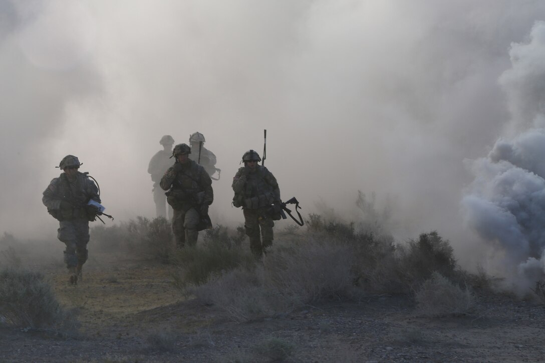 Soldiers move under the cover of smoke during Decisive Action Rotation 16-06 at the National Training Center at Fort Irwin, Calif., May 16, 2016. The soldiers are assigned to the 3rd Infantry Division’s 1st Battalion, 28th Infantry Regiment. Army photo by Spc. Kyle Edwards