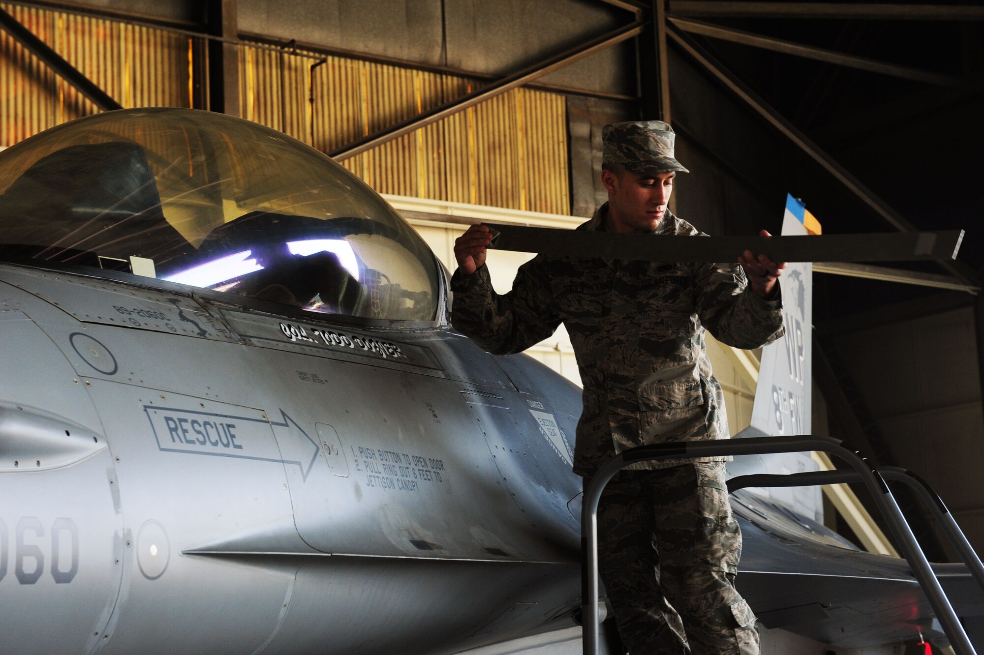 Airman 1st Class Jonathan Kolb, 35th Aircraft Maintenance Unit assistant dedicated crew chief, changes the name on the 8th Fighter Wing’s flagship aircraft to the new wing commander, Col. Todd Dozier, May 20, 2016 at Kunsan Air Base, Republic of Korea. (U.S. Air Force photo by Senior Airman Ashley L. Gardner/Released)
