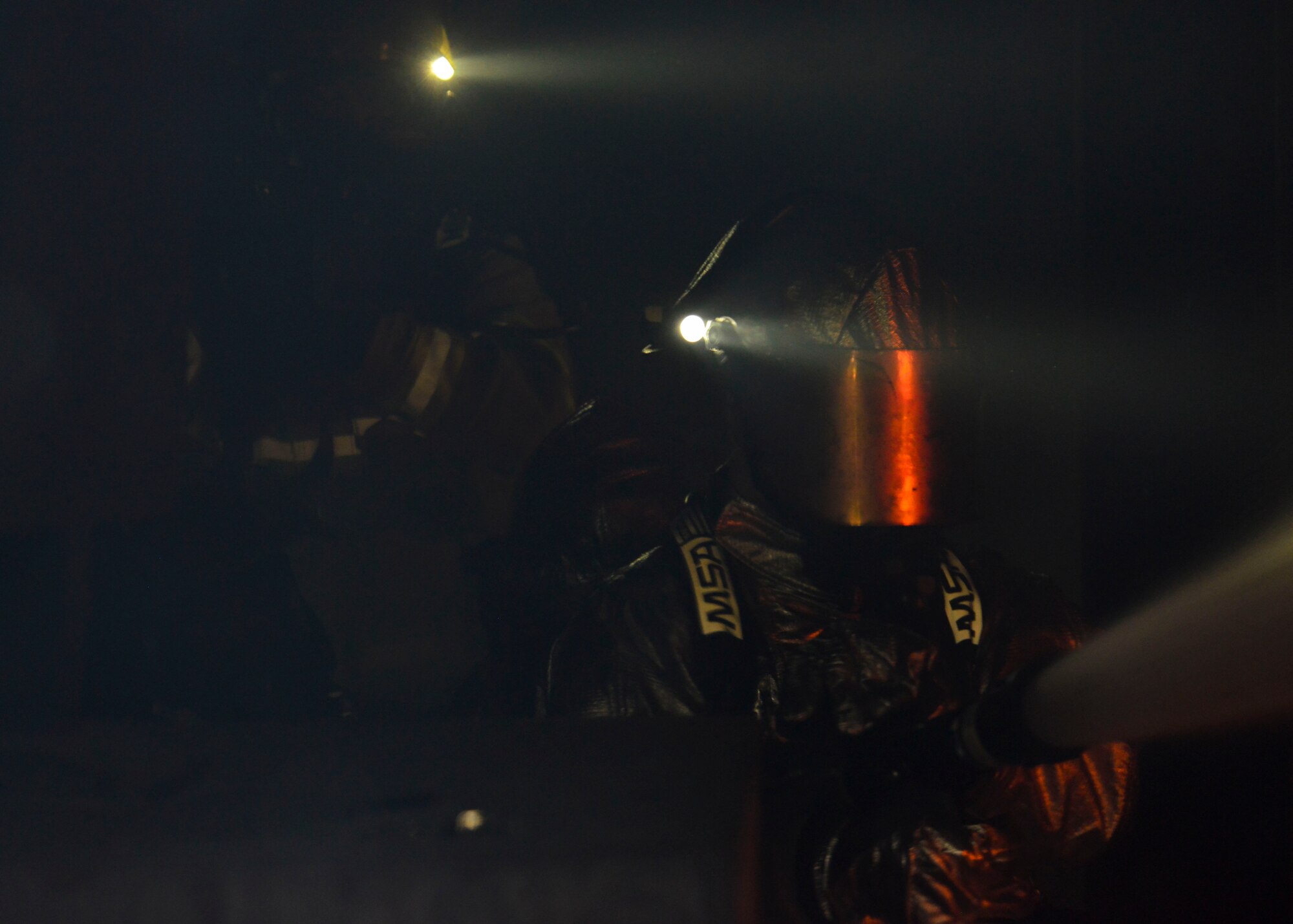 Firefighters from the 51st Civil Engineer Squadron fire and emergency services flight douse a fire during structural live fire training at the Kyonggi-do Fire Academy, Republic of Korea, May 18, 2016. Small teams of firefighters tested their ability to extinguish structural fires inside high-heat, low-visibility situations during the training. (U.S. Air Force photo by Senior Airman Victor J. Caputo/Released)