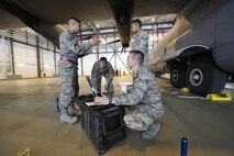 Tech. Sgt. Roscoe Tamondong, 86th Maintenance Group NCO in-charge instructor element (left), gives Airmen in the crew chief training course guidance on performing tire pressure checks on a C-130J Super Hercules May 17, 2016 at Ramstein Air Base, Germany. Tamondong is one of four training instructors assigned to the 86th MXG. (U.S. Air Force photo/Staff Sgt. Leslie Keopka)
