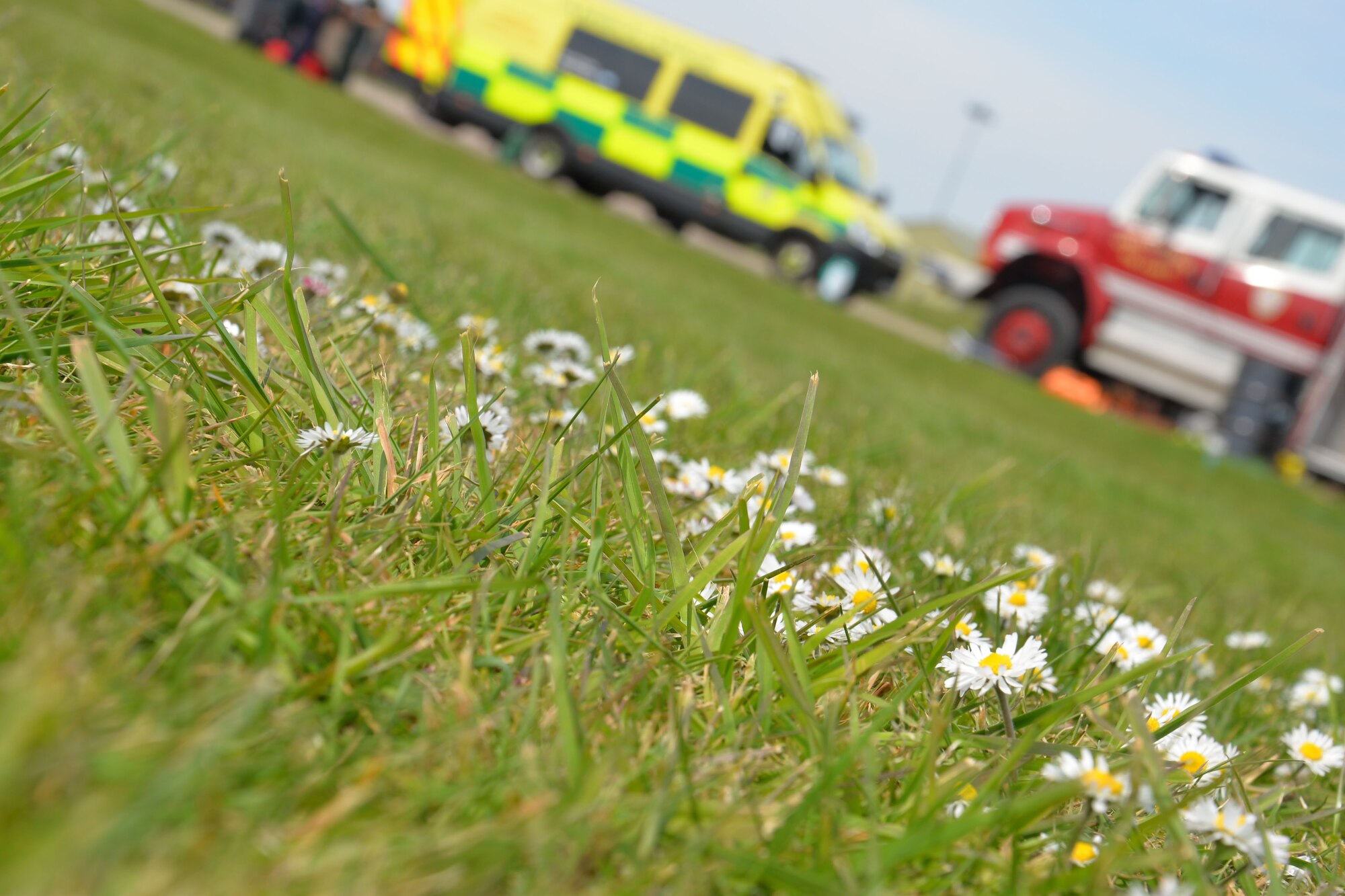 U.S. Air Force 100th Civil Engineer Squadron fire trucks stand ready with vehicles from the East of England Ambulance Service during a training exercise May 6, 2016, on RAF Mildenhall, England. Members of the 100th CES Fire Department teamed up with host nation emergency service responders to share skills and knowledge. (U.S. Air Force photo by Gina Randall/Released)