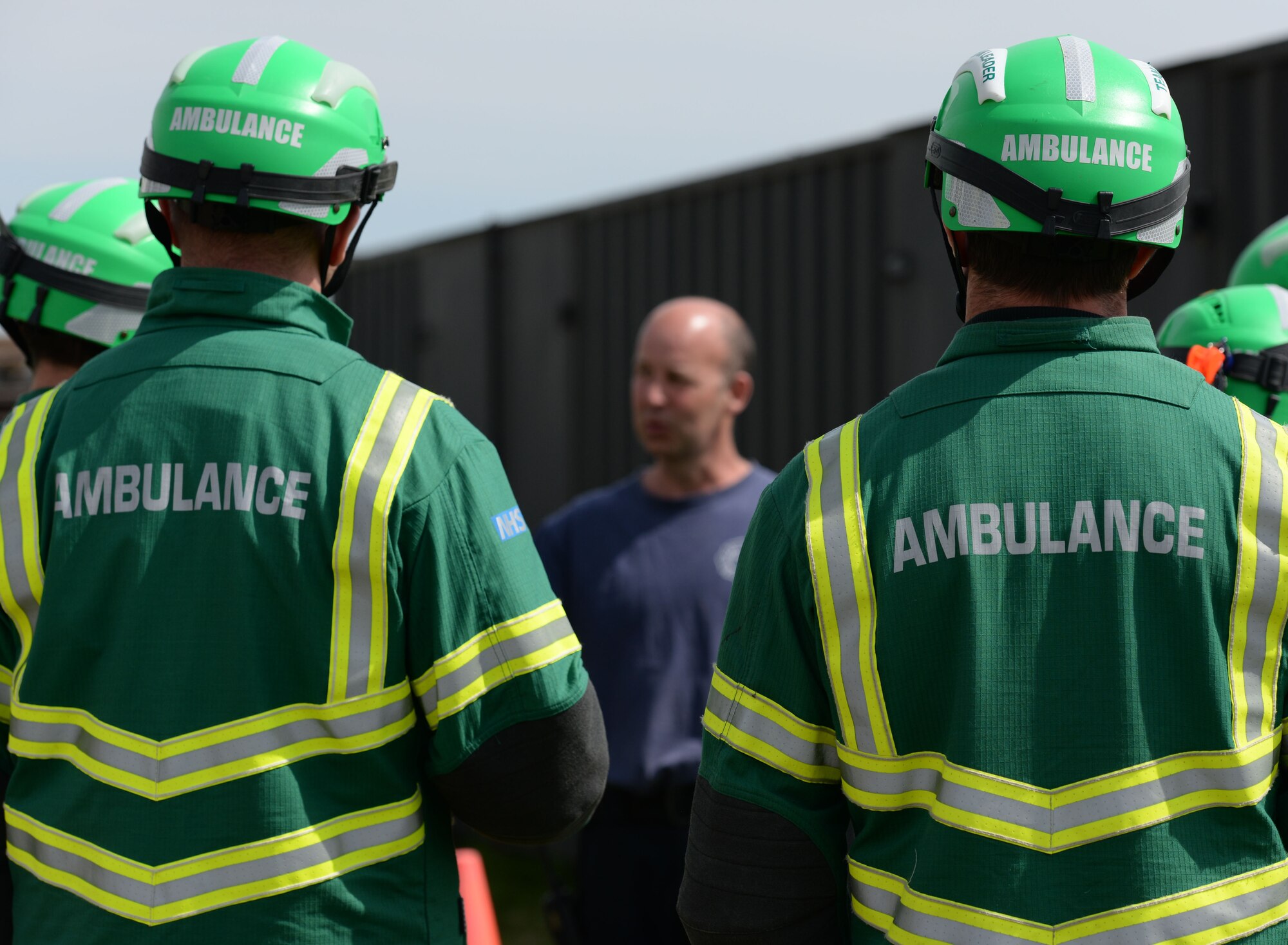 Crew Manager Andrew Hughes, center, 100th Civil Engineer Squadron firefighter, briefs East of England Ambulance Service Hazardous Area Response Team members on confined-space entry procedures May 6, 2016, on RAF Mildenhall, England. Following training, Hughes debriefed the team with ‘lessons learnt.’ (U.S. Air Force photo by Gina Randall/Released)