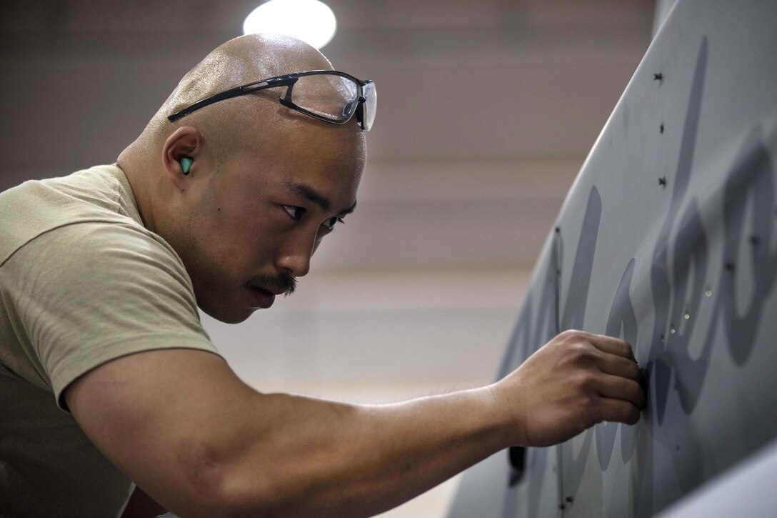Air Force Tech. Sgt. Rene Garcia secures a screw for a panel on an F-16C Fighting Falcon aircraft during routine phase maintenance at Bagram Airfield, Afghanistan, May 18, 2016. Garcia is a phase technician assigned to the 455th Expeditionary Aircraft Maintenance Squadron. Air Force photo by Senior Airman Justyn M. Freeman