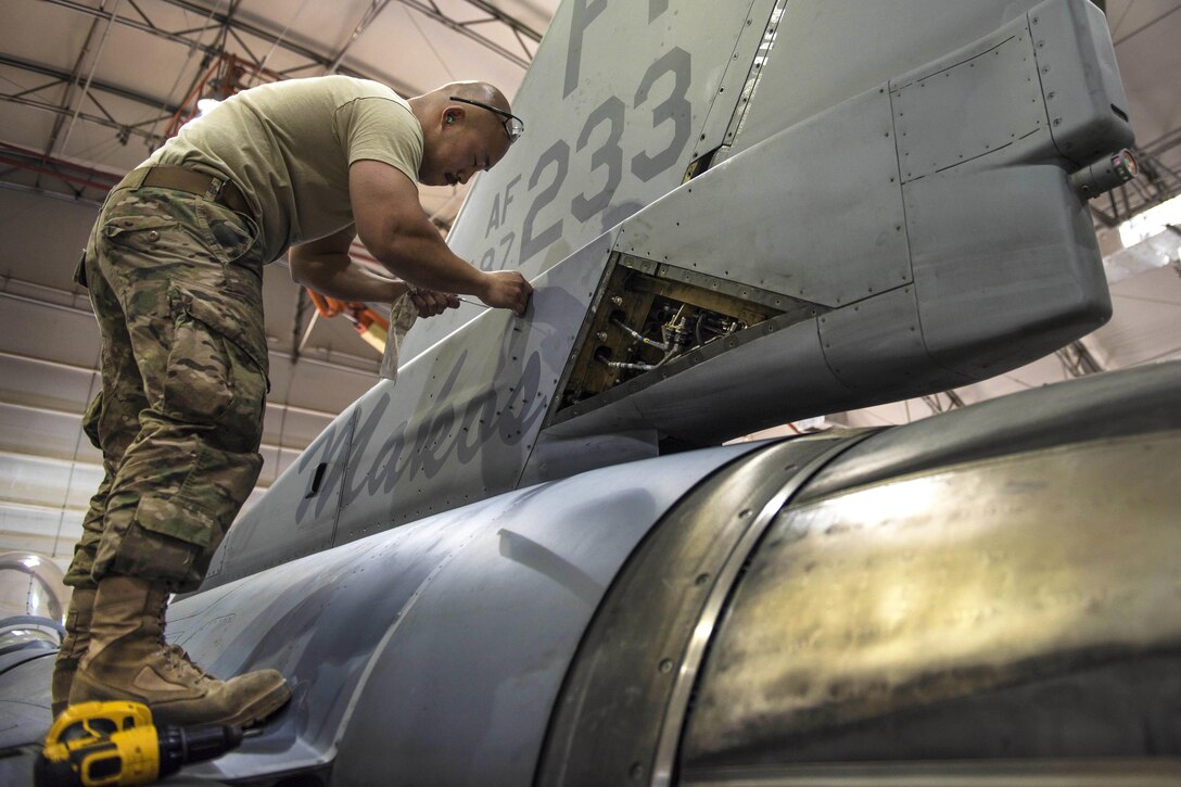 Air Force Tech. Sgt. Rene Garcia replaces a panel on an F-16C Fighting Falcon aircraft during routine phase maintenance at Bagram Airfield, Afghanistan, May 18, 2016. Garcia is a phase technician assigned to the 455th Expeditionary Aircraft Maintenance Squadron. Air Force photo by Senior Airman Justyn M. Freeman