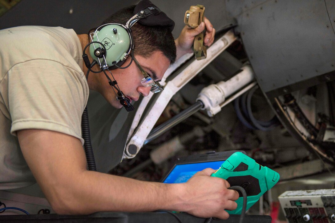 Air Force Staff Sgt. Alexander Corral looks at the technical order for an F-16C Fighting Falcon aircraft during routine phase maintenance at Bagram Airfield, Afghanistan, May 18, 2016. Corral is a phase technician assigned to the 455th Expeditionary Aircraft Maintenance Squadron. Air Force photo by Senior Airman Justyn M. Freeman
