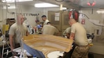 Army National Guard sheet metal repairers in Company B, 640th Aviation Support Battalion, 40th Combat Aviation Brigade, work on an MQ-1C Gray Eagle composite frame at Camp Buehring, Kuwait, March 5. This is the first ASB to work on Gray Eagle composite parts during an overseas deployment.