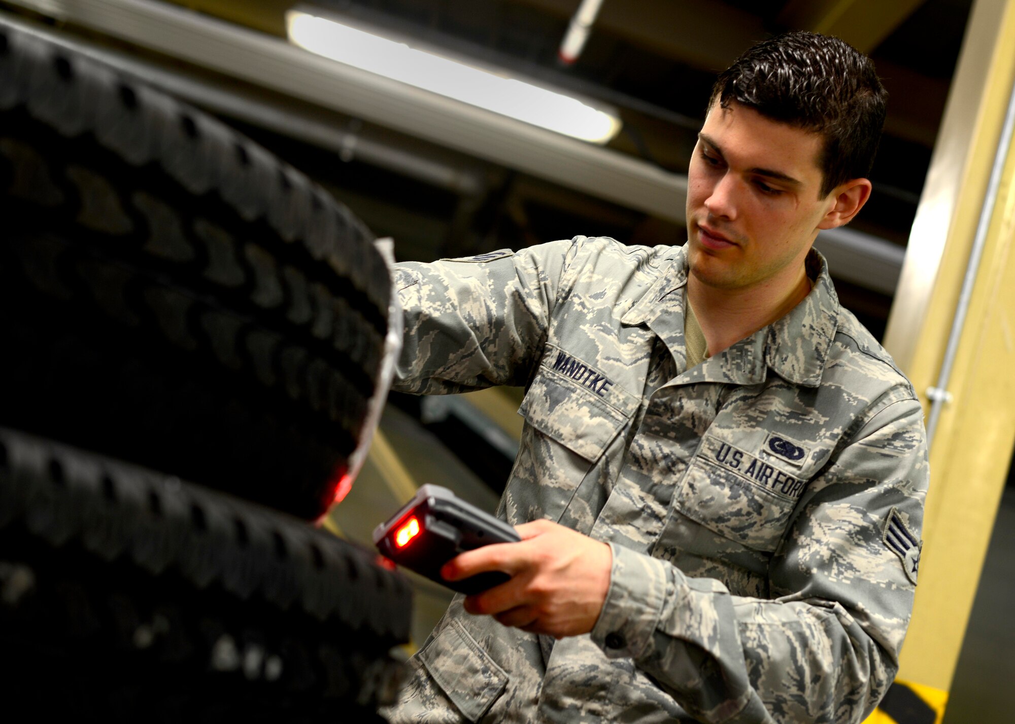 Senior Airman Tyler Wandtke, 31st Logistics Readiness Squadron aircraft parts store journeyman, uses a hand held terminal to log items, May 19, 2016 at Aviano Air Base, Italy. Wandtke used his passion for technology to create Enterprise Solution Supply— also known as ESSential, which streamlines organization of collected data. (U.S. Air Force photo by Senior Airman Areca T. Bell/Released)