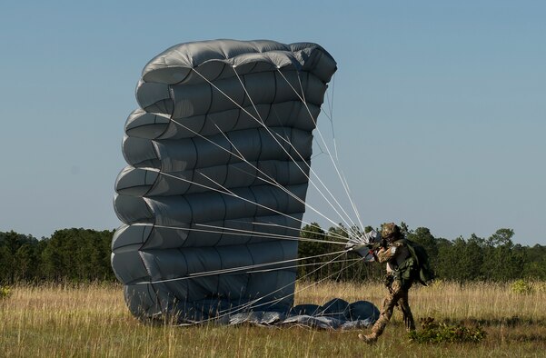 An Airman assigned to the 24th Special Operations Wing lands after parachuting from an Army CH-47 Chinook during exercise Emerald Warrior 16 over Eglin Range, Fla., May 7, 2016. Emerald Warrior is a U.S. Special Operations Command-sponsored mission rehearsal exercise during which joint special operations forces train to respond to real and emerging worldwide threats. (U.S. Air Force photo/Senior Airman Trevor T. McBride)