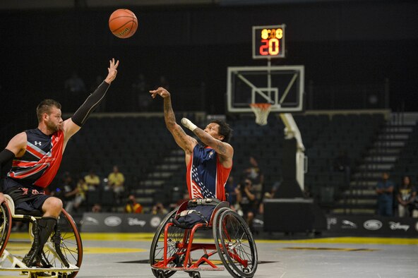 Retired U.S. Marine Corps Sgt. Anthony McDaniel shoots over a U.K. defender in the championship wheelchair basketball game at Invictus Games 2016 in Orlando, Fla., May 12, 2016. The 2016 Invictus Games were composed of 15 nations with over 500 military competitors competing in 10 sporting events from May 8-12. (U.S. Air Force photo/Tech. Sgt. Joshua L. DeMotts)