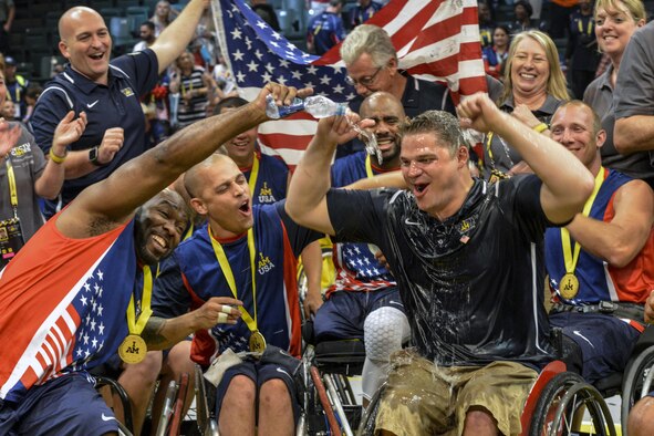 Team U.S. and Team U.K. celebrate after the wheelchair basketball championship match during the 2016 Invictus Games at the ESPN Wide World of Sports Complex in Orlando, Fla., May 12, 2016. The U.S. took gold and the U.K. took silver, while Denmark took home bronze. The next Invictus Game is scheduled to take place in Toronto. (U.S. Air Force photo/Senior Master Sgt. Kevin Wallace)