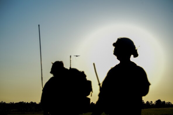 Special tactics Airmen assigned to the 24th Special Operations Wing observe an MC-130J Commando II approach during exercise Emerald Warrior 16 at Camp Shelby Joint Forces Training Center, Miss., May 7, 2016. Emerald Warrior is a U.S. Special Operations Command-sponsored mission rehearsal exercise during which joint special operations forces train to respond to real and emerging worldwide threats. (U.S. Air Force photo/Senior Airman Colville McFee)