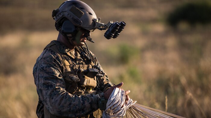 A reconnaissance man with the Maritime Raid Force, 11th Marine Expeditionary Unit, secures his parachute after an air insert into a reconnaissance and surveillance mission at a MEU field exercise aboard Marine Corps Base Camp Pendleton, Calif., May 12, 2016. The Maritime Raid Force provides a unique capability to the MEU commander and can respond to a number of mission requirements the MEU may respond to such as visit, board, search and seizure, reconnaissance and surveillance, and direct action raids. 