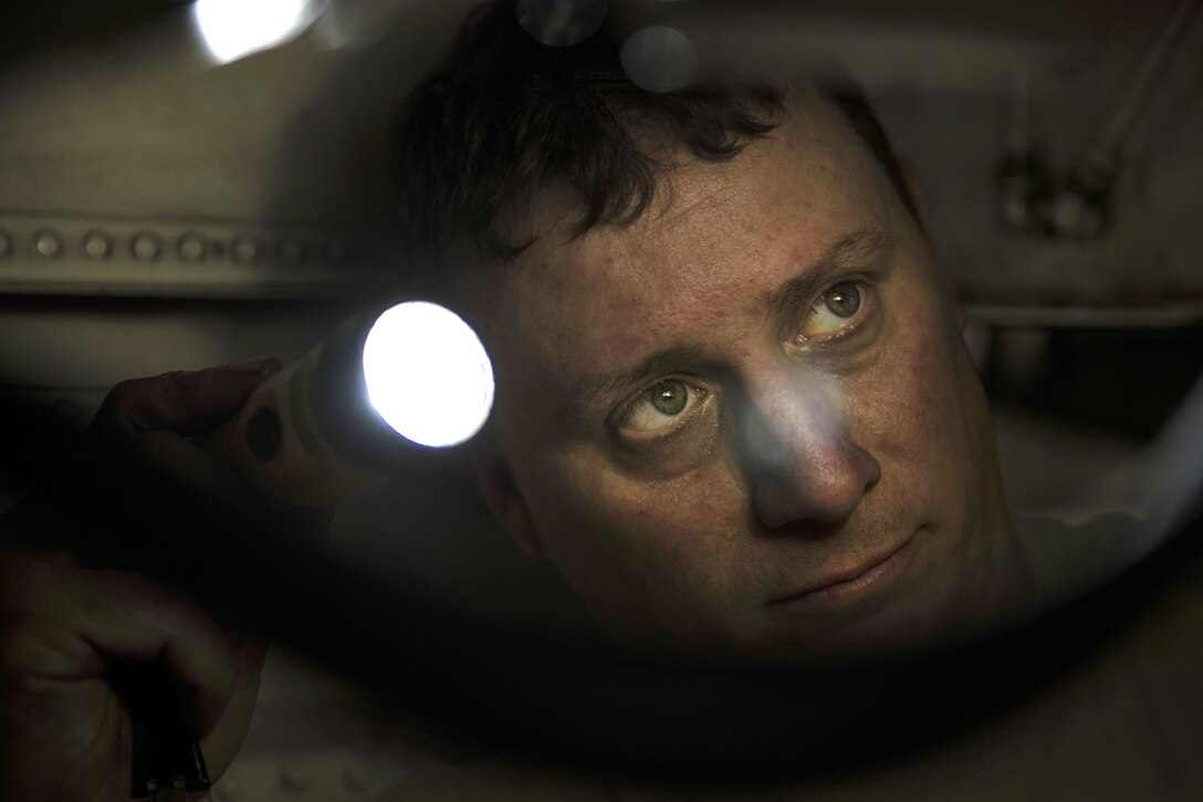 Air Force Tech. Sgt. Christopher Melrose inspects the interior of an F-16C Fighting Falcon during routine phase maintenance at Bagram Airfield, Afghanistan, May 18, 2016. Melrose is a phase technician assigned to the 455th Expeditionary Aircraft Maintenance Squadron. Air Force photo by Senior Airman Justyn M. Freeman