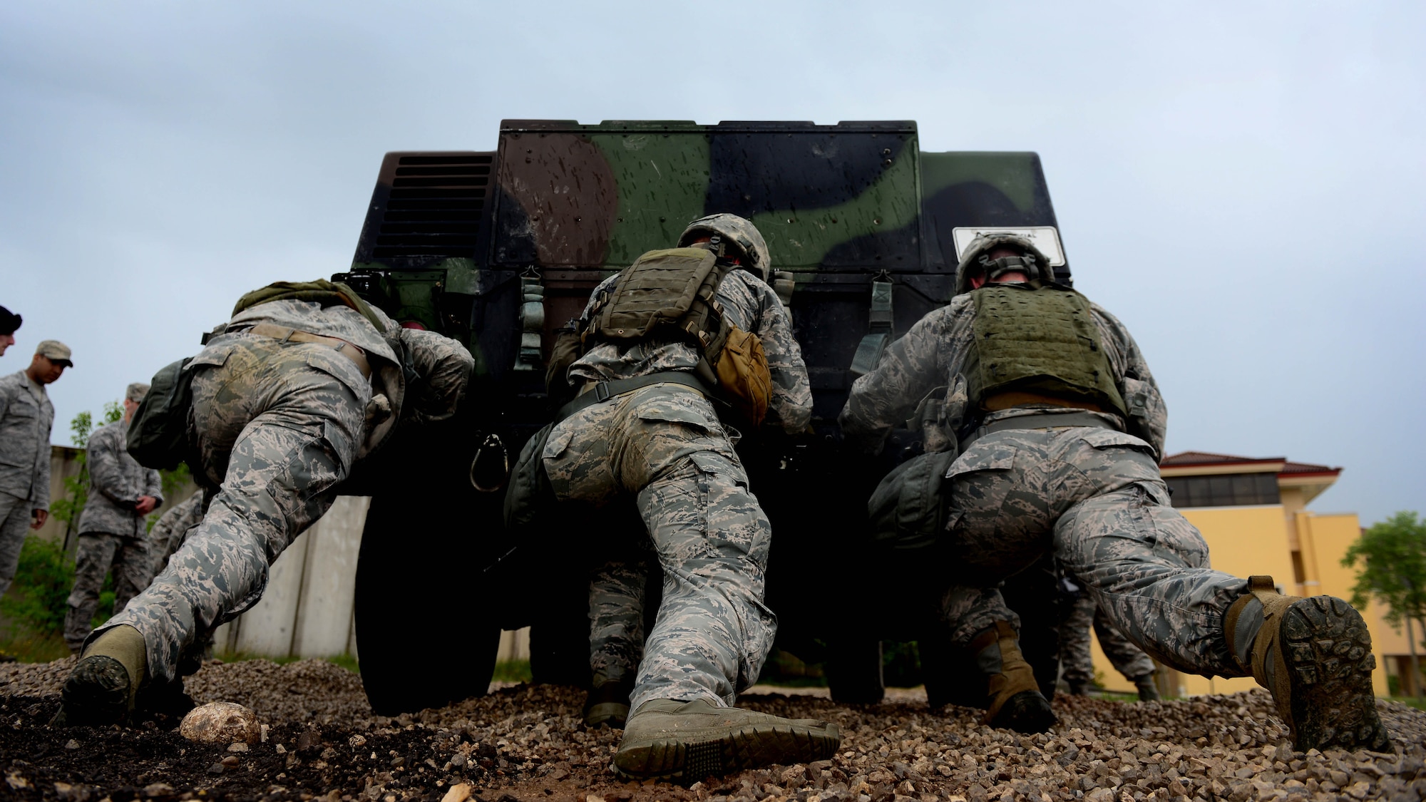 Airmen assigned to the 31st Security Forces Squadron, push a Humvee during the Police Week Fire Team Challenge, May 19, 2016, at Aviano Air Base, Italy. During the week, ceremonies, a memorial and other events took place to honor the men and women who have served in the line of duty. (U.S. Air Force photo by Senior Airman Areca T. Bell/Released)