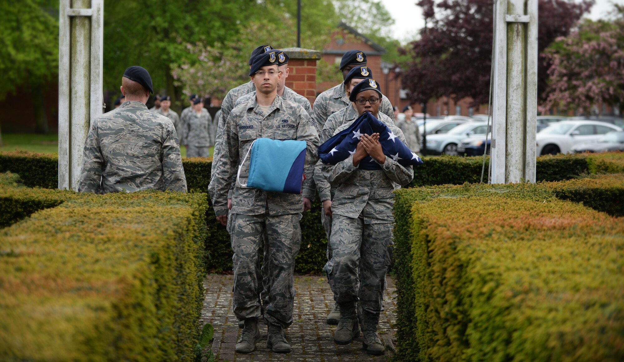 U.S. Air Force Airmen from the 100th Security Forces Squadron march with the Royal Air Force ensign and American flag during a retreat ceremony May 19, 2016, on RAF Mildenhall, England. This event was hosted by the 100th SFS as part of National Police Week. National Police Week is held to honor those who have fallen in the line of duty. (U.S. Air Force photo by Senior Airman Christine Halan/Released) 