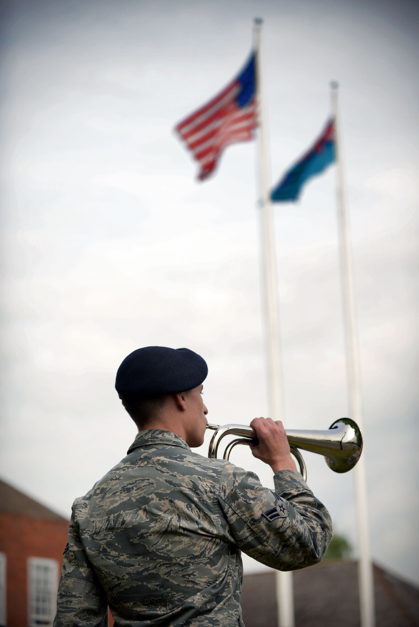 U.S. Air Force Airman 1st Class Nathaniel John, 100th Security Forces Squadron defender, plays Taps on the bugle during a retreat ceremony May 19, 2016, on RAF Mildenhall, England. Taps is played in honor of those who have fallen in the line of duty. (U.S. Air Force photo by Senior Airman Christine Halan/Released)