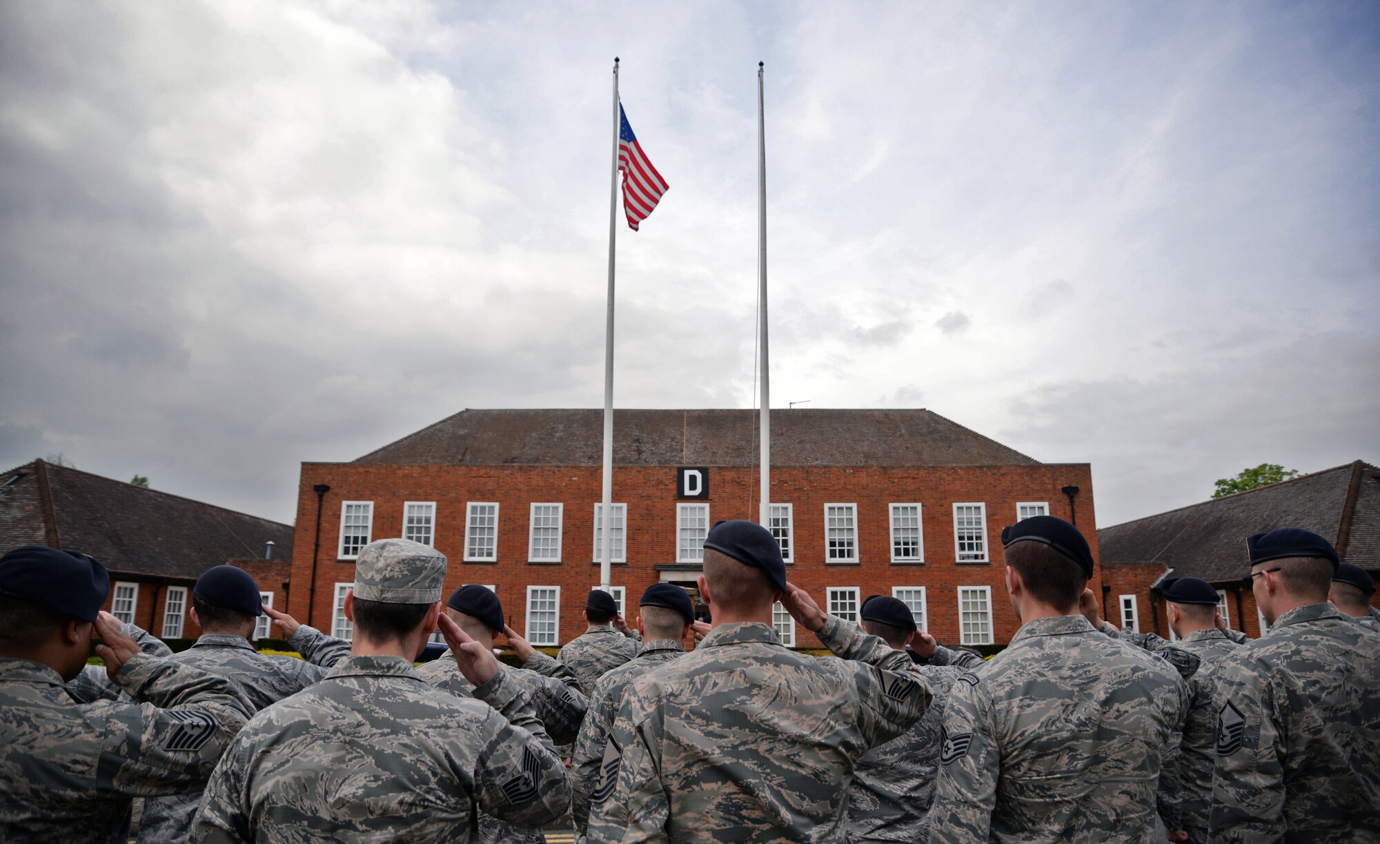 U.S. Air Force Airmen from the 100th Security Forces Squadron salute during a retreat ceremony May 19, 2016, on RAF Mildenhall, England. The retreat ceremony was one of many events held for National Police Week. (U.S. Air Force photo by Senior Airman Christine Halan/Released)
