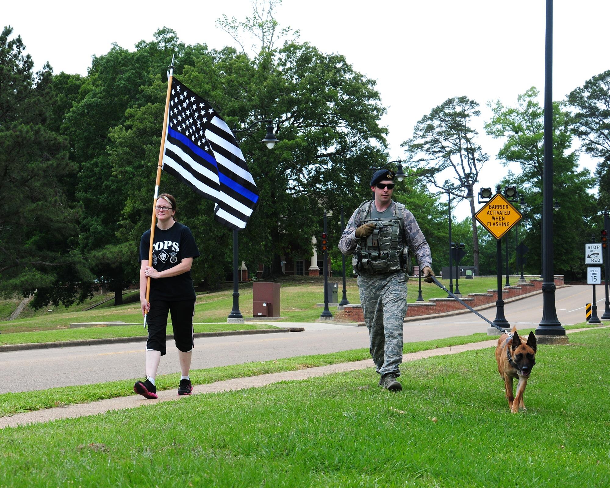 Lisa Pender and Staff Sgt. Karl Stefanowicz, both from the 14th Security Forces Squadron, participate in a 24-Hour Fallen Defender March May 16 on Columbus Air Force Base, Mississippi, to kick-off Police Week 2016. During National Police Week, security forces defenders and local law enforcement officers demonstrated their capabilities and daily responsibilities to the base and the public as well as honored fallen defenders. (U.S. Air Force photo/ Elizabeth Owens)