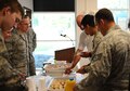 Members of the Chapel set up tables with juice, biscuits and books for Team BLAZE members in the wing headquarters building May 17 at Columbus Air Force Base, Mississippi. They used the opportunity to talk about freedom of religion, spiritual resilience and more. (U.S. Air Force photo/Senior Airman Kaleb Snay)
