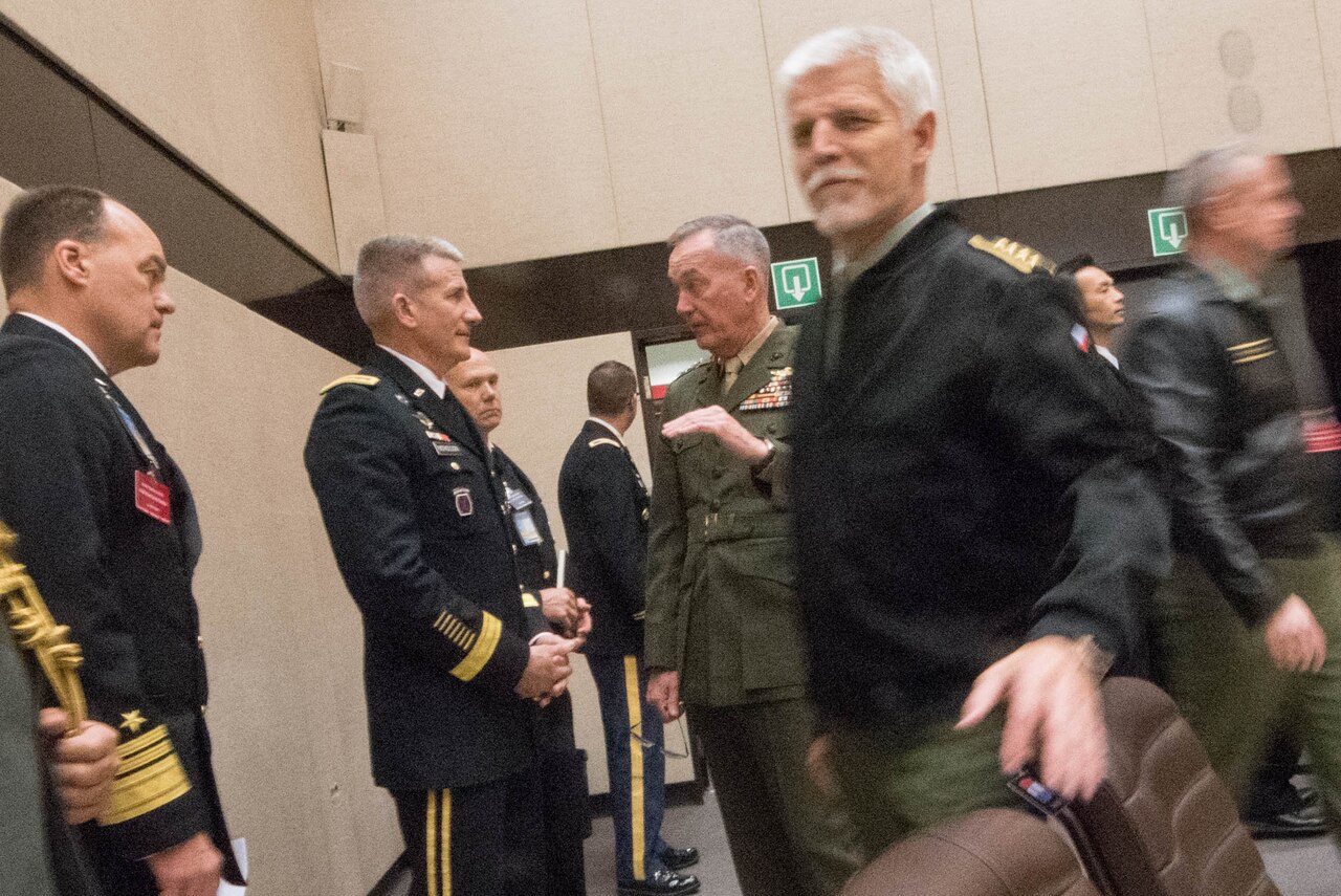 Marine Corps Gen. Joe Dunford, chairman of the Joint Chiefs of Staff, center, talks with Army Gen. John W. Nicholson Jr., commander of NATO's Resolute Support mission, at the Military Committee/Chiefs of Defense session in Brussels, Belgium, May 18, 2016. DoD photo by D. Myles Cullen