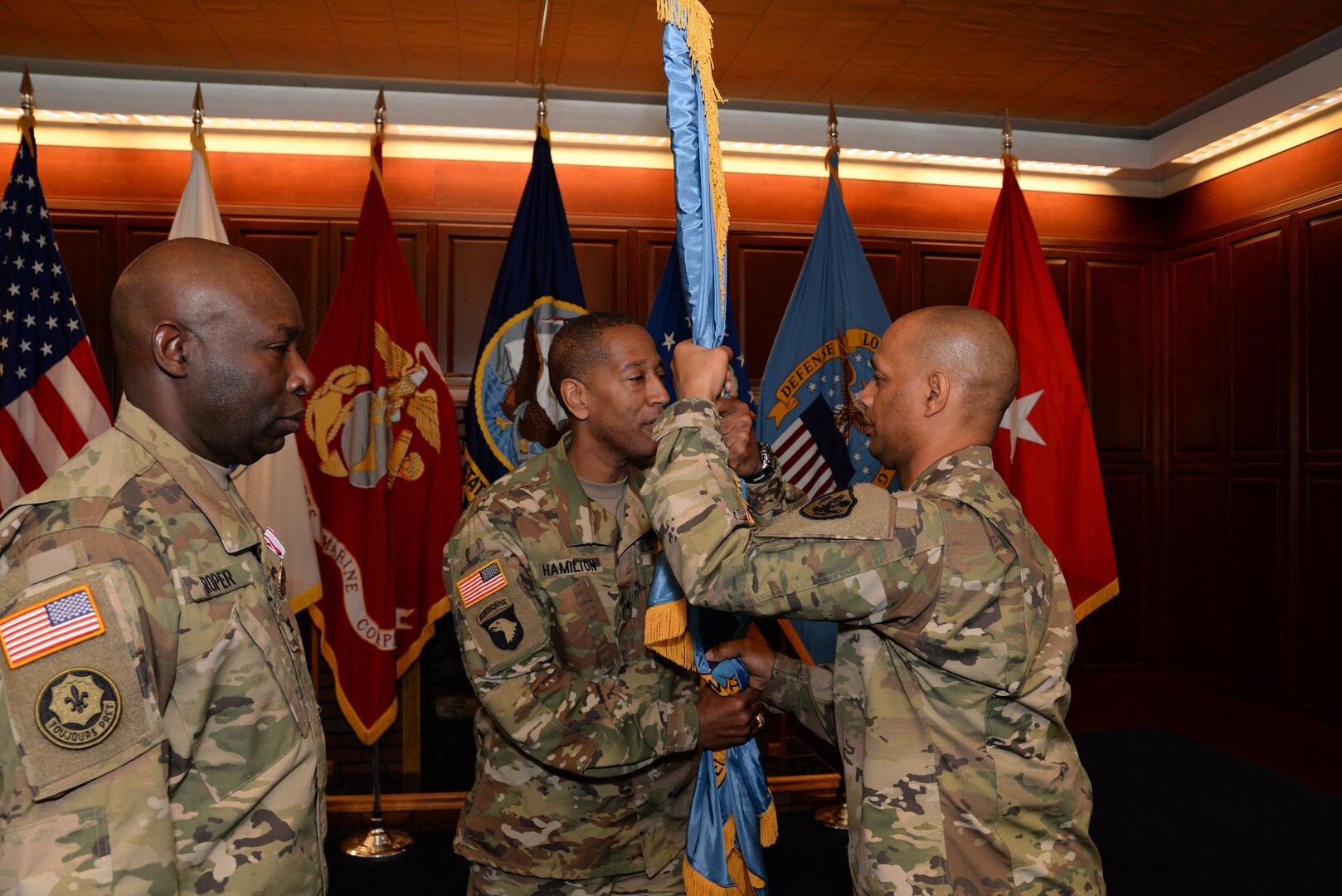 Army Brig. Gen. Charles Hamilton, DLA Troop Support Commander, gives the colors to Army Col. Ronnie Davis, giving him command of the DLA’s Army Reserve Element in a change of command ceremony May 15 at the McNamara Headquarters Complex, Fort Belvoir, Virginia.