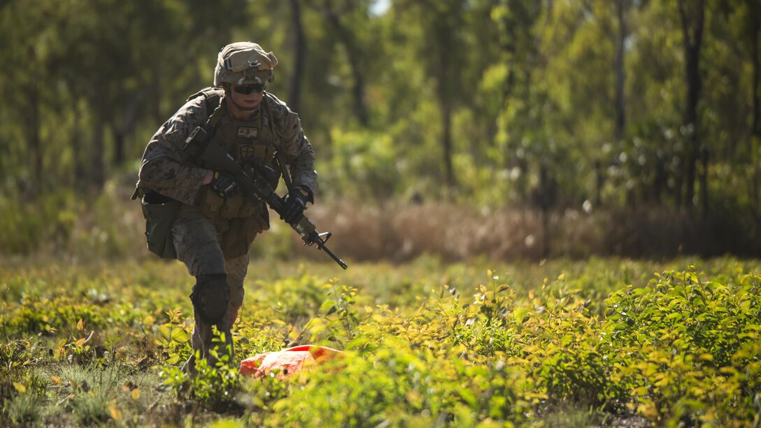 Lance Cpl. Karl-Andrew Perkins, a rifleman, places an air panel to signal a UH-1Y Venom helicopter to a landing zone outside of Robertson Barracks, Northern Territory, Australia, May 20, 2016. Marines with Marine Rotational Force - Darwin simulated causality evacuations with a UH-1Y Venom helicopter. MRF-D is a six-month deployment of Marines into Darwin, Australia, training in a new environment. Perkins, from Grove City, Pennsylvania, is with Company B, 1st Battalion, 1st Marine Regiment, MRF-D.