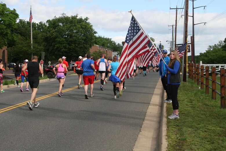 The Wear Blue Run to Remember Mile was a new feature of the Marine Corps Historic Half. Pictures of Marines killed in action lined Sophia Street in Fredericksburg along with volunteers bearing American flags.