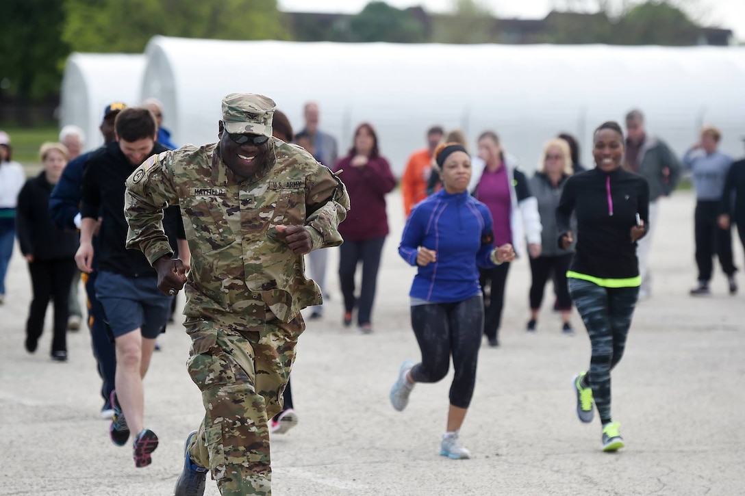 Col. D.D. Mayfield, Defense Contract Management Agency-Chicago, takes off in a sprint during the annual DCMA 'Walk to Wellness' event at the Paul G. Schulstad Army Reserve Center, May 18, 2016. Members from DCMA and the 85th Support Command participate in the run that brings out staff to interact and conduct brief fitness there.
(Photo by Sgt. Aaron Berogan)