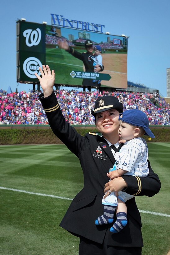 First Lt. Jiaru Bryar, 85th Support Command, with her 10-month-old, Mason, stands on Wrigley Field for a miitary spotlight during the Chicago Cubs Mother's Day game. 
(Photo by Sgt. 1st Class Anthony L. Taylor)