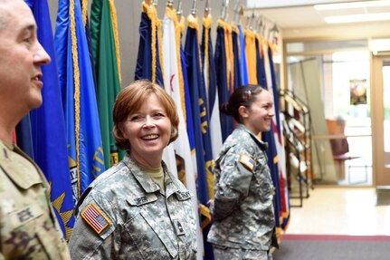 Master Sgt. Melody Tuper, center, looks on as Command Sgt. Maj. Kevin Greene, left, 85th Support Command, recounts a story about Tuper, 85th Support Command, during her last Battle Assembly with the command. Tuper is retiring this summer from the Army after serving more than 30 plus years. 
(Photo by Spc. David Lietz)